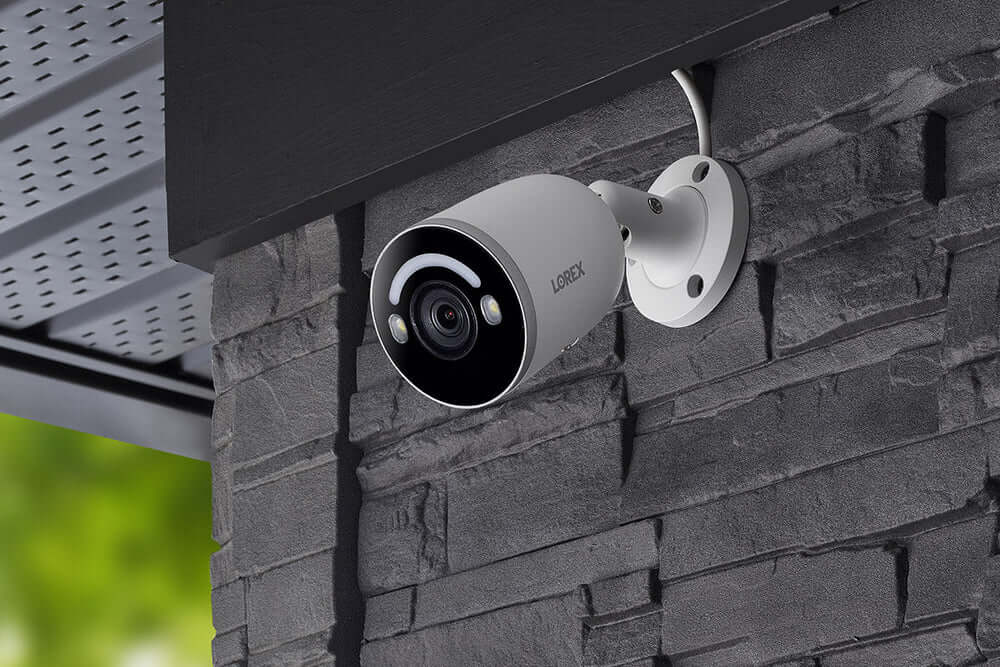 Lorex 4K IP Smart Detection Bullet Camera installed on a wall, ideal for security lighting at Cabin Depot.