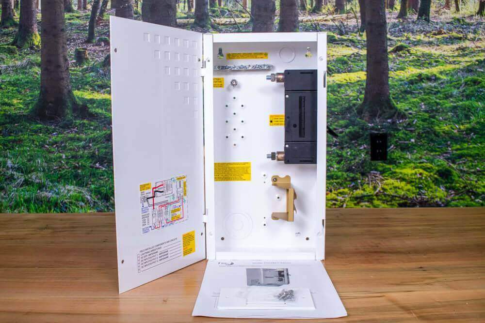 MidNite 175A Mini DC Disconnect with open white aluminum chassis and 175A/125VDC breaker, shown in a forest-themed setting.