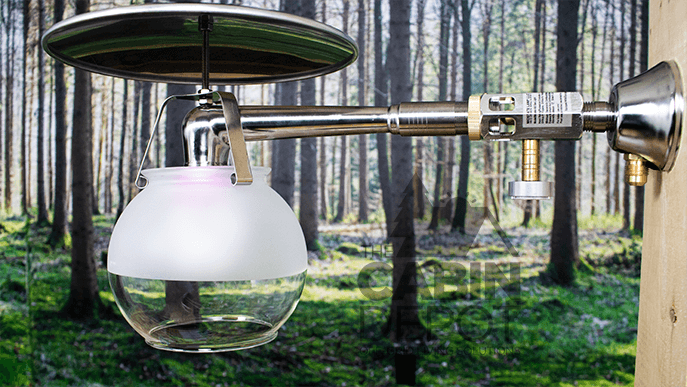 Midstate Model 450 indoor propane lamp from Cabin Depot, showing sleek design, high brightness, and off-grid usability in forest setting.