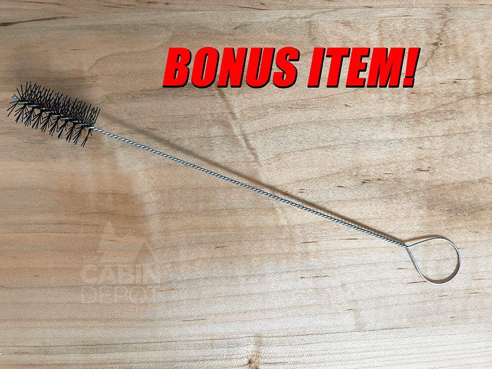 Wire cleaning brush bonus item from Cabin Depot displayed on wooden surface.