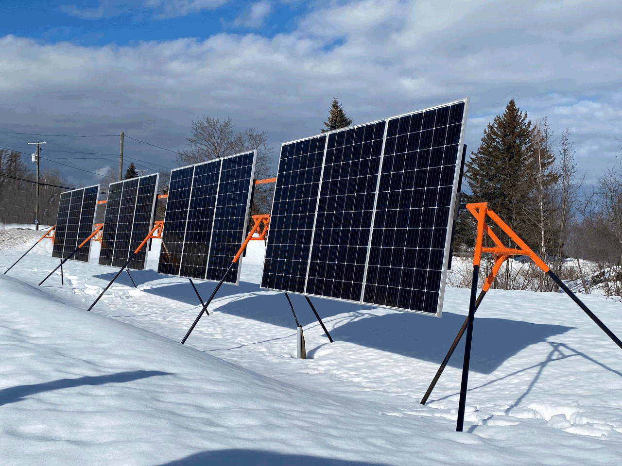 Trifecta 12-Panel Ground Mount Kit by Cabin Depot. Adjustable solar mount system in snowy landscape, Canada.