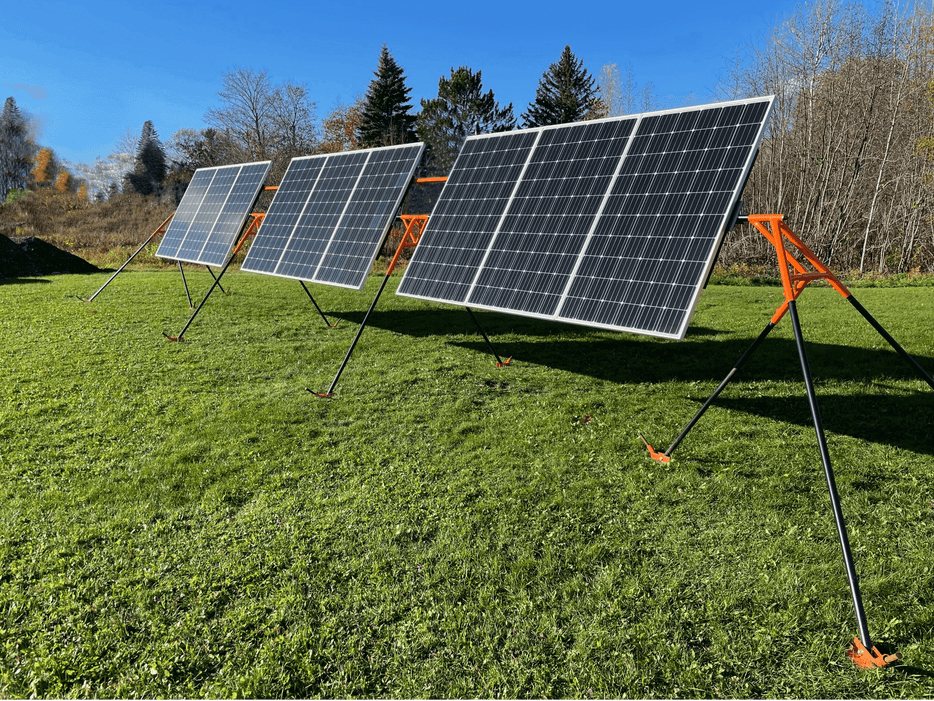 Trifecta 9-Panel Solar Ground Mount Kit in use, featuring adjustable steel mounts and 300W Mono GMA solar panels on grass.