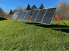 Trifecta 9-Panel Ground Mount Kit installed in a grassy field, showcasing fully adjustable solar panels for easy setup.