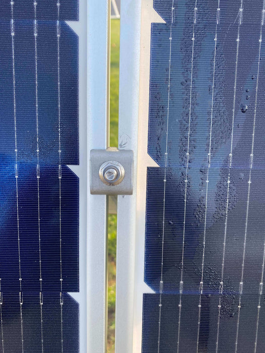 Close-up of solar panel secured with Trifecta Ground Mount Panel Adapter Kit bracket system for optimal energy production.