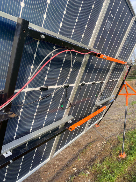 Solar panels mounted on a Trifecta Ground Mount Panel Adapter Kit for optimal energy production.