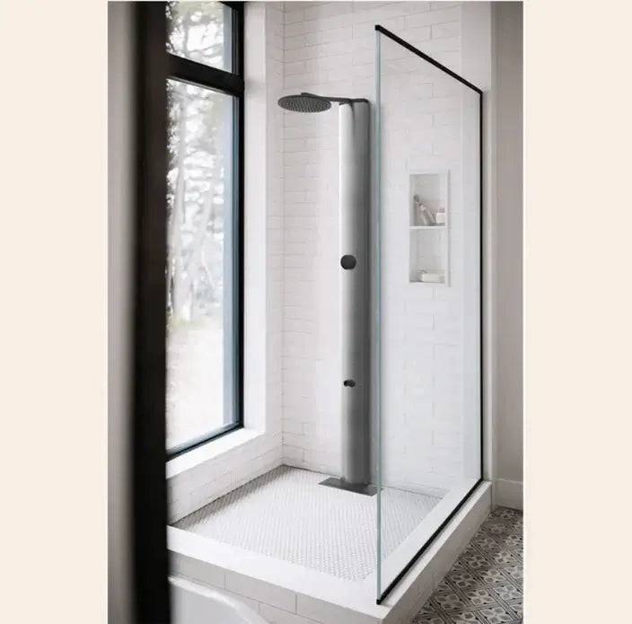 Brushed nickel RainStick shower in modern bathroom with glass enclosure and sleek design.