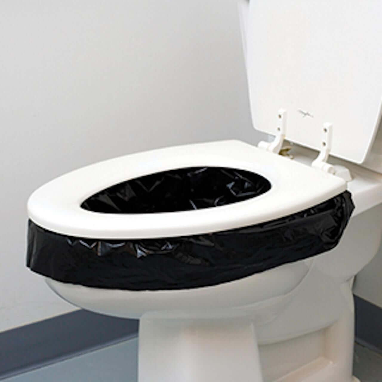 Reliance Double Doodie Plus Waste Bags fitted on toilet seat for mess-free portable toilet use, available at Cabin Depot.