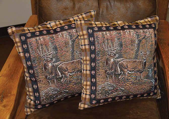 Two Rivers Edge 18" Bear Tapestry Pillows on a chair, featuring nature art, ideal for home or cabin decor.