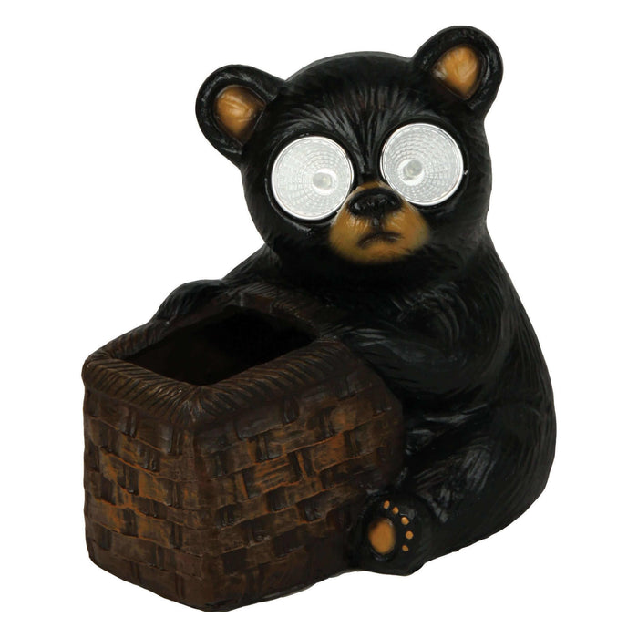 Solar-powered bear garden light with a basket, hand painted poly resin design, ideal for outdoor decoration, charges in sunlight.