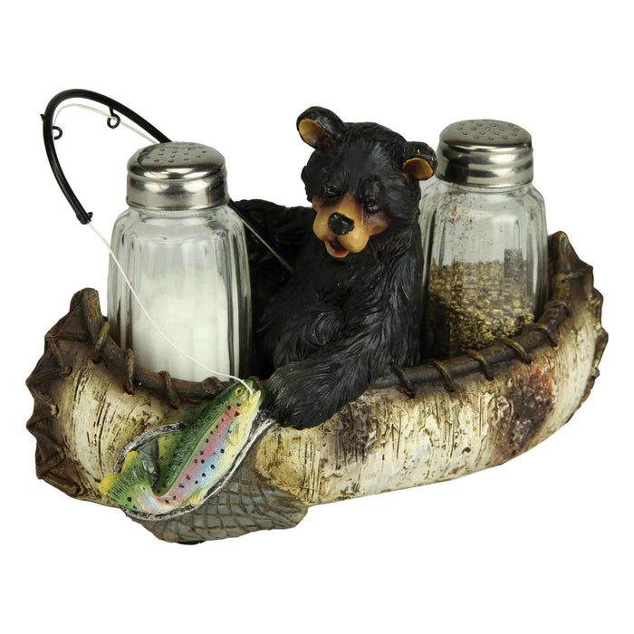 Fishing bear salt and pepper shaker set with hand-painted bear, canoe, and trout, featuring glass shakers in playful design.