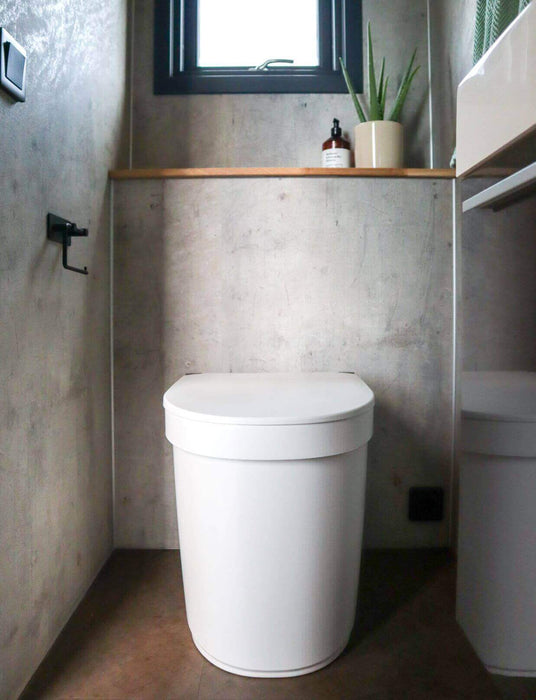 Separett Tiny 1270 compact toilet in a modern, minimalist bathroom setting, designed for eco-friendly small spaces.