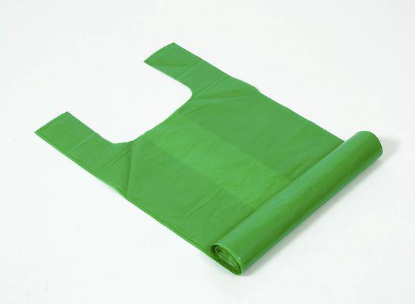 Green biodegradable compost bags in a roll, perfect for eco-friendly waste management solutions in kitchens and gardens.