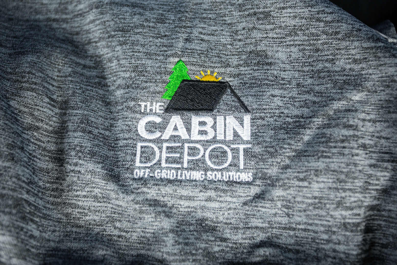 Cabin Depot XL Men's Charcoal Heathered Hoodie with logo, 100% polyester, comfortable and stylish for off-grid living.