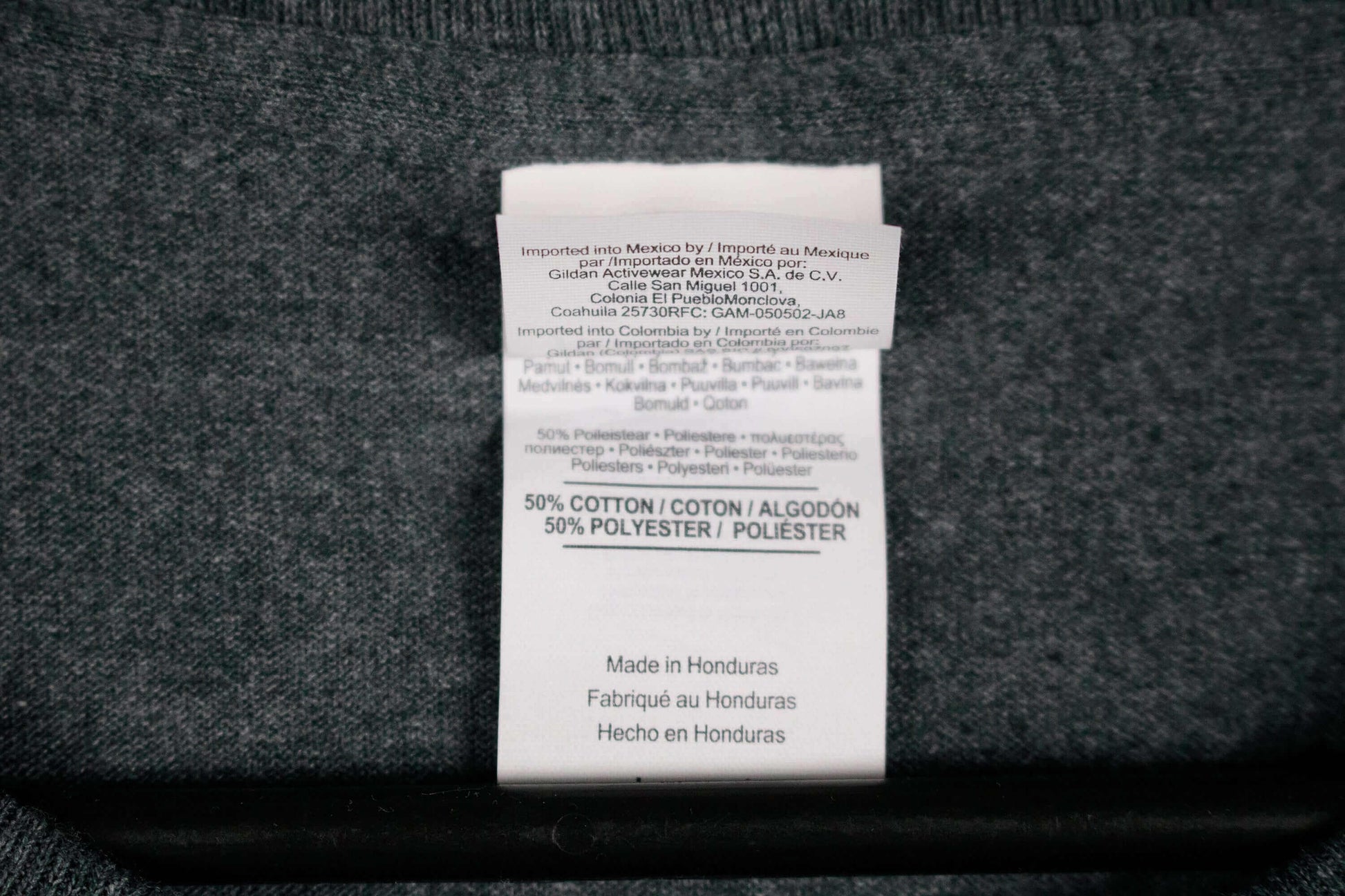 Label of The Cabin Depot Medium Women's Heathered T-Shirt in Grey showing 50% cotton and 50% polyester blend, made in Honduras.