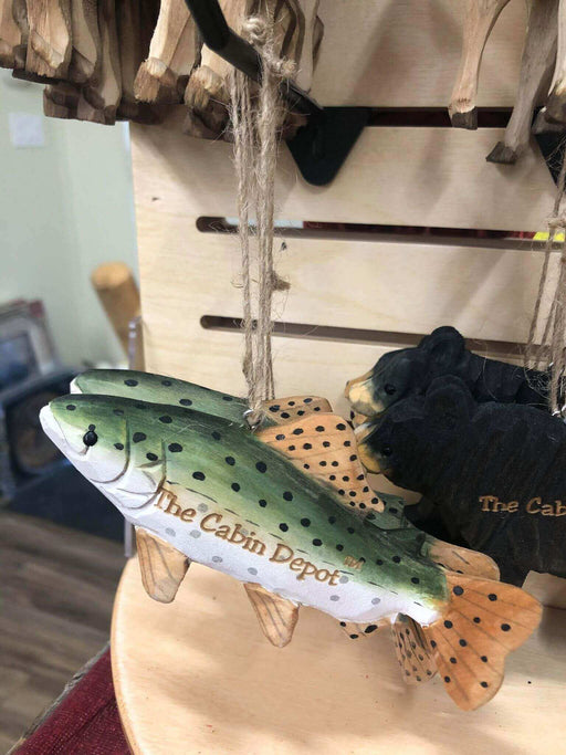 Handcrafted NWL wooden fish ornament by The Cabin Depot hanging on display.