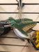 Handcrafted wooden bird ornaments from The Cabin Depot hanging on display, showcasing natural green and brown tones.