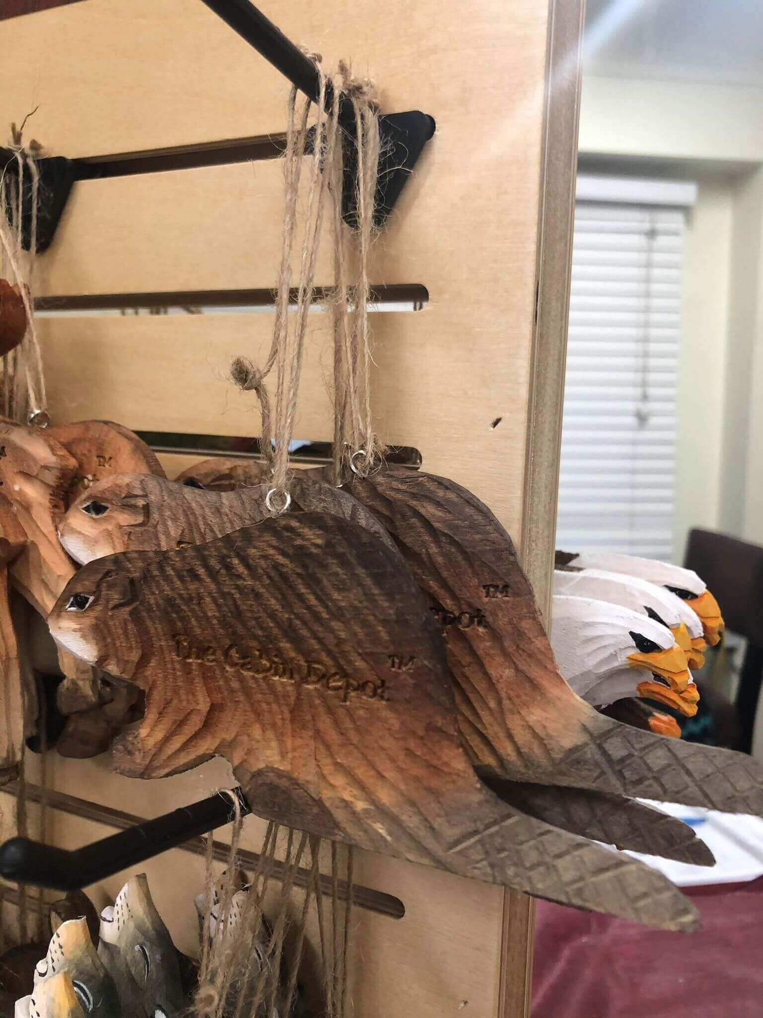 Hand crafted wooden bird ornaments by The Cabin Depot, hanging display. NWL Wooden Ornament collection for rustic decor.