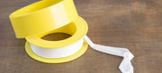Martin Teflon Pipe Thread Tape PTFE from Cabin Depot on a wooden surface, ideal for sealing plumbing joints.