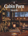 "Cabin Porn Inside book cover showcasing cozy cabin interior with a warm fireplace and snowy scenery outside."