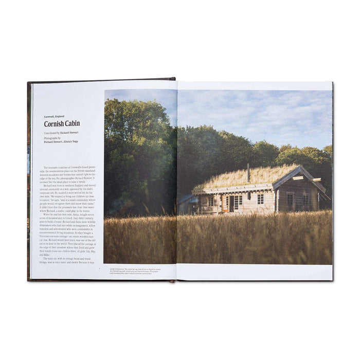 Open book showing a tranquil cabin in nature, from "Cabin Porn Inside" featuring inspiring handmade homes.