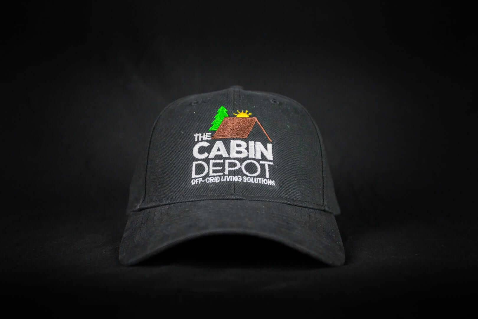Black Cabin Depot hat featuring adjustable back and logo, suitable for off-grid living enthusiasts. One size fits all.
