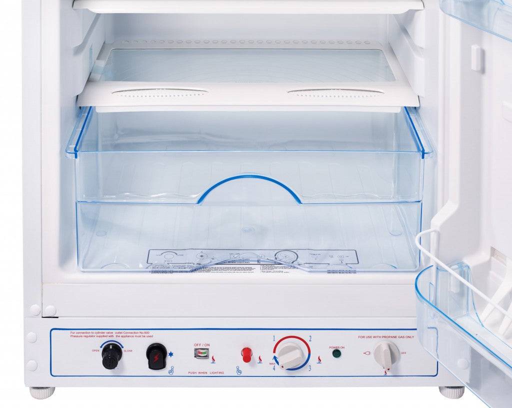 Open view of Unique 8 cu/ft propane fridge interior with large freezer, sold at Cabin Depot, showcasing adjustable shelves and controls.
