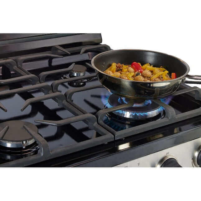 Cooking on a Unique 30-inch stainless steel propane range with cast-iron grates, available at Cabin Depot.