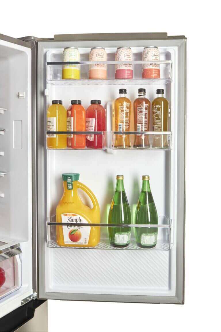 Open door of Unique 12 Cu/Ft Prestige Electric Bottom Mount Refrigerator showing organized beverages, available at Cabin Depot.