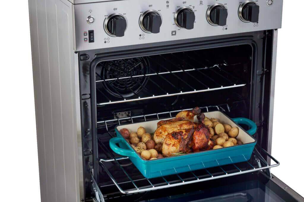 Stainless steel Prestige 24" electric range with convection and smooth-top, featuring roasted chicken and potatoes. Cabin Depot.