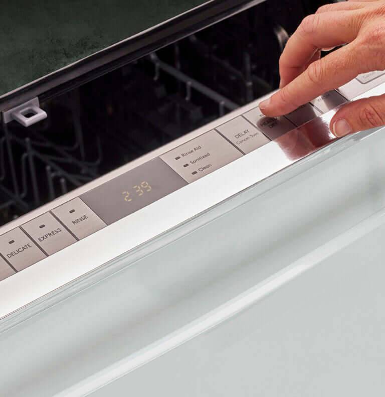 Alt Tag: User operating controls on a Unique 24" Classic Retro Dishwasher at Cabin Depot with chrome accents and retro design features.