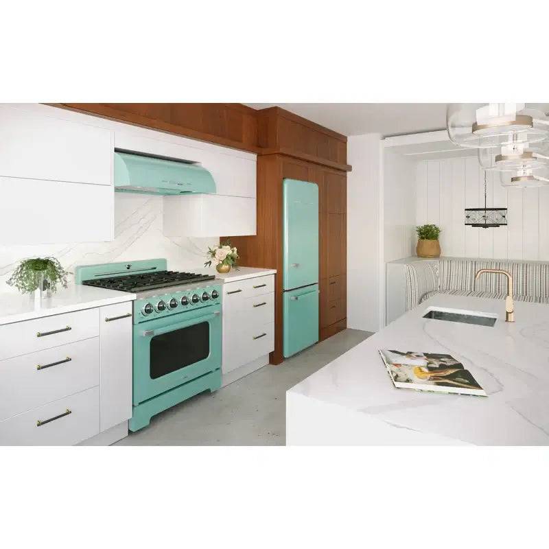 Mint green 36" classic retro range hood by Unique in a modern kitchen, styled with chrome accents and matching oven. Available at Cabin Depot.