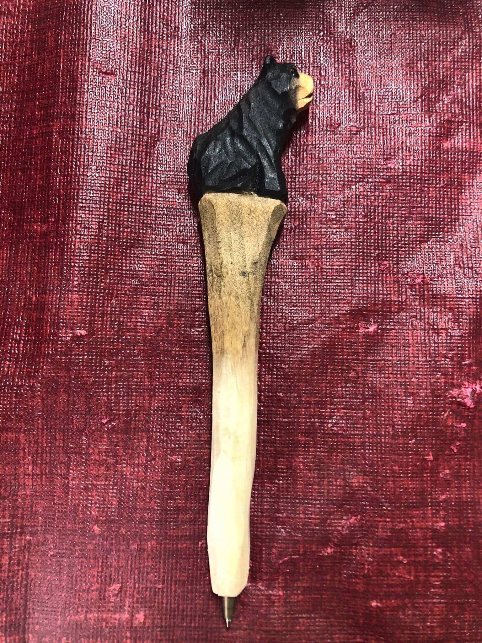 Wood-Carved Bear Head Pen from Cabin Depot on red background