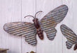 Galvanized butterfly hanger 18-inch on wall, perfect for indoor and outdoor decor in gardens, homes, and garages.