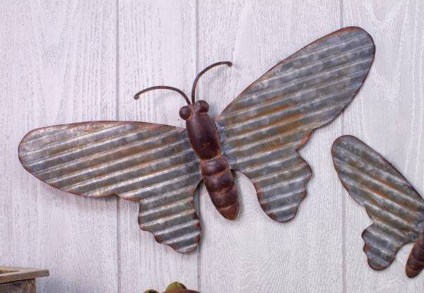 Galvanized butterfly hanger 18-inch on wall, perfect for indoor and outdoor decor in gardens, homes, and garages.