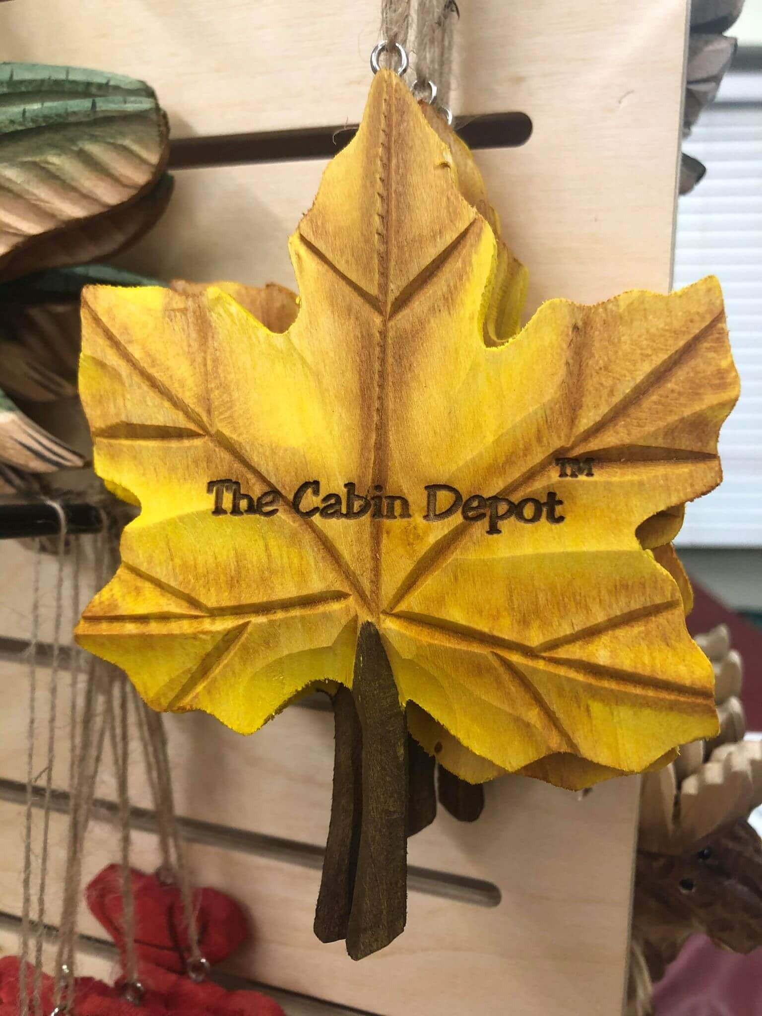 Hand-crafted maple leaf ornament from The Cabin Depot, showcasing detailed wooden design and craftsmanship. Ideal cabin decor.