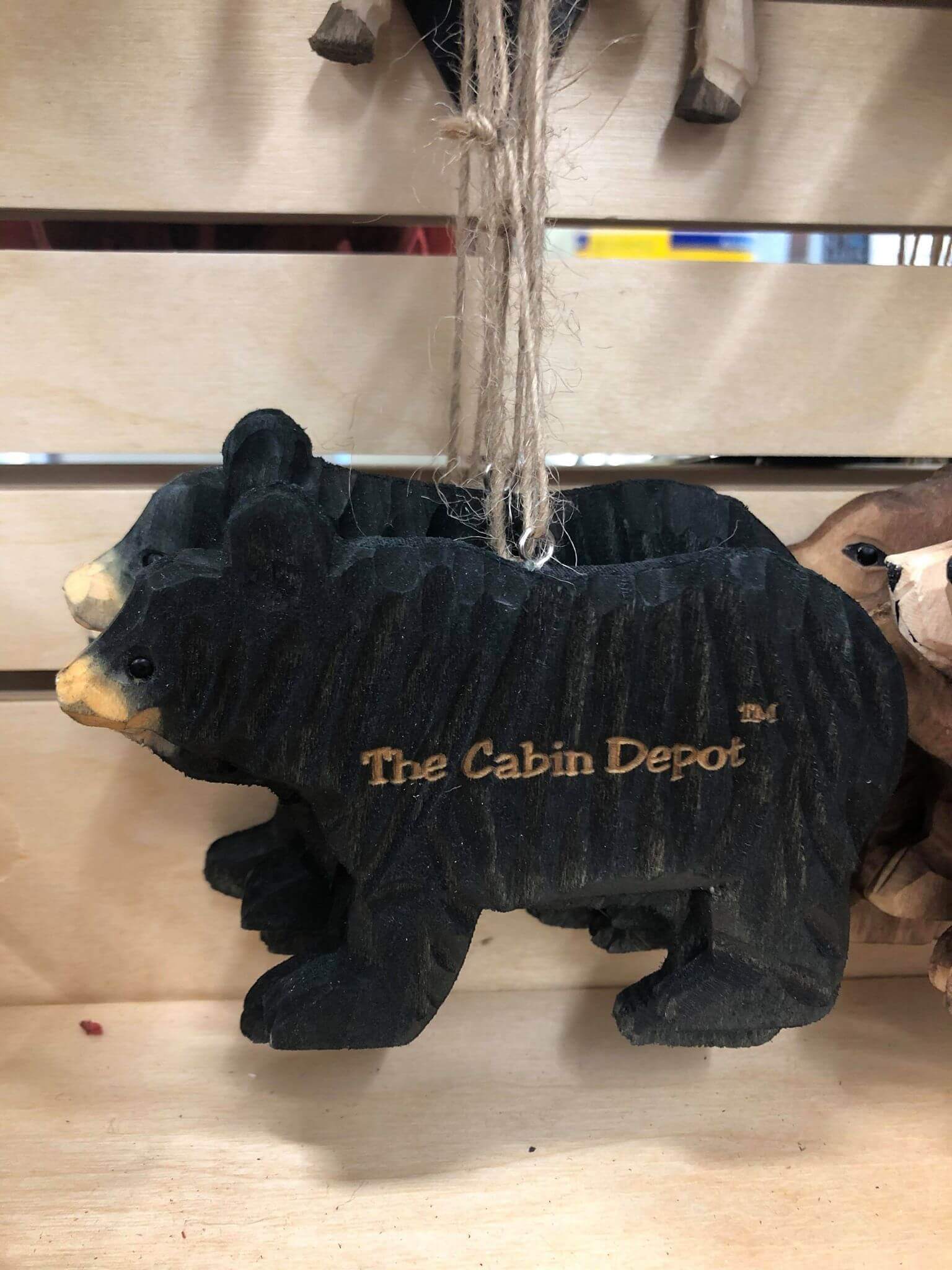 Hand crafted wooden bear ornament from The Cabin Depot, featuring intricate detailing for rustic home decor.