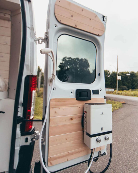 Eccotemp EL5 Luxe outdoor portable tankless water heater mounted on van door, showcasing versatility and ease of use.