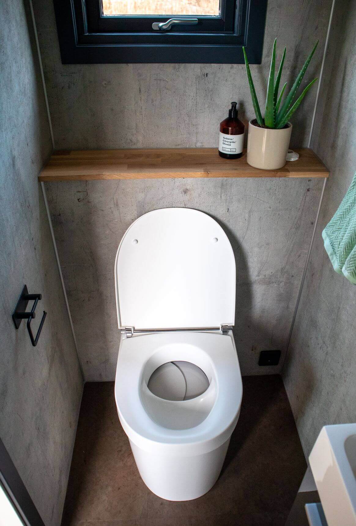 Separett Tiny 1270 Toilet with Internal Urine Tank in small modern washroom, ideal for cabins, tiny houses, and boats. Available at Cabin Depot.