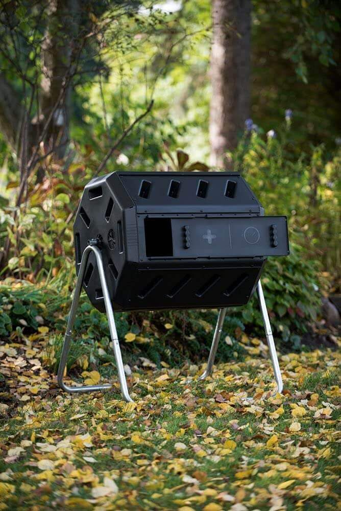 FCMP Outdoor Dual Chamber Tumbling Composter in garden setting, efficient compost bin from Cabin Depot.