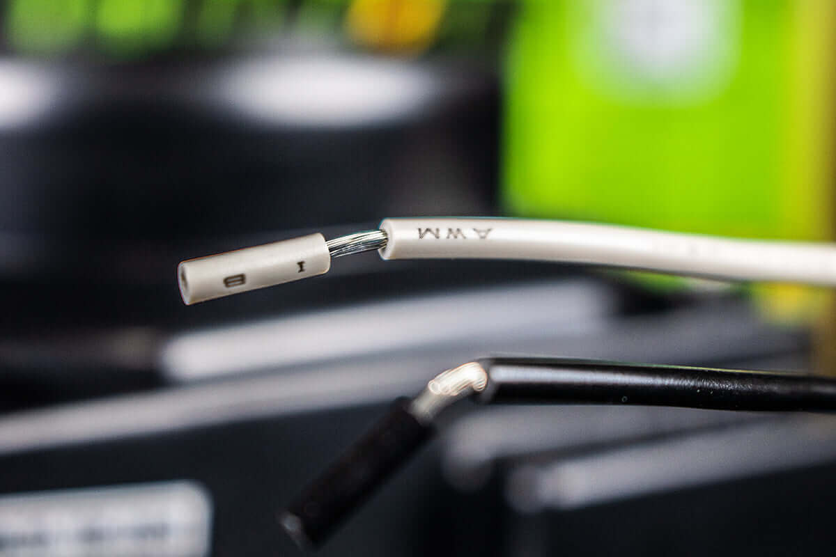 Close-up of wiring connectors for Kedron 12V DC exhaust fan from Cabin Depot, ideal for waterproof ventilation in off-grid setups.