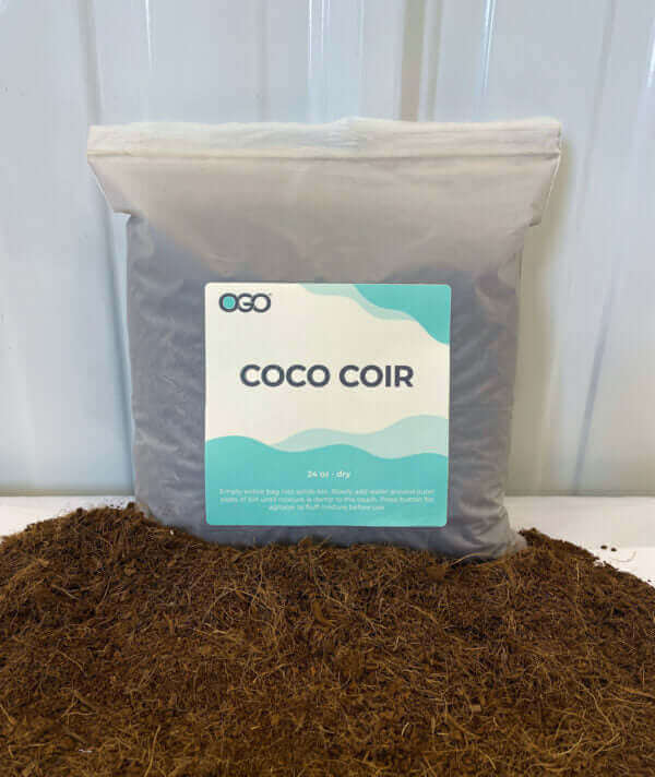 Bag of OGO Coco Coir next to loose coir fibers, ideal for gardening and plant growth.