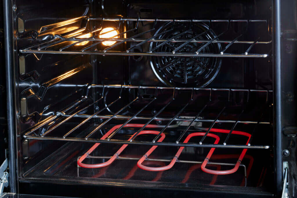 Interior view of Prestige 24'' electric range with convection heating, available at Cabin Depot, highlighting sleek and efficient design.