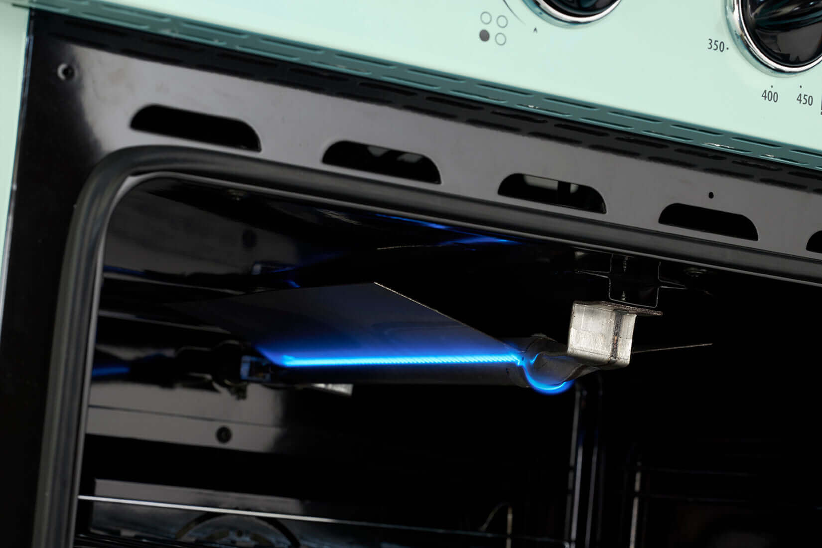 Interior view of Unique 30" Classic Retro Propane Off-Grid Range showcasing blue flame in oven, available at Cabin Depot.