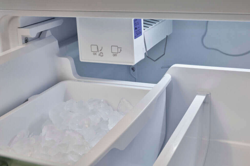 Ice compartment inside the 18 Cu Ft Classic Retro Bottom Mount Refrigerator from Cabin Depot, featuring a white finish and energy-efficient design.