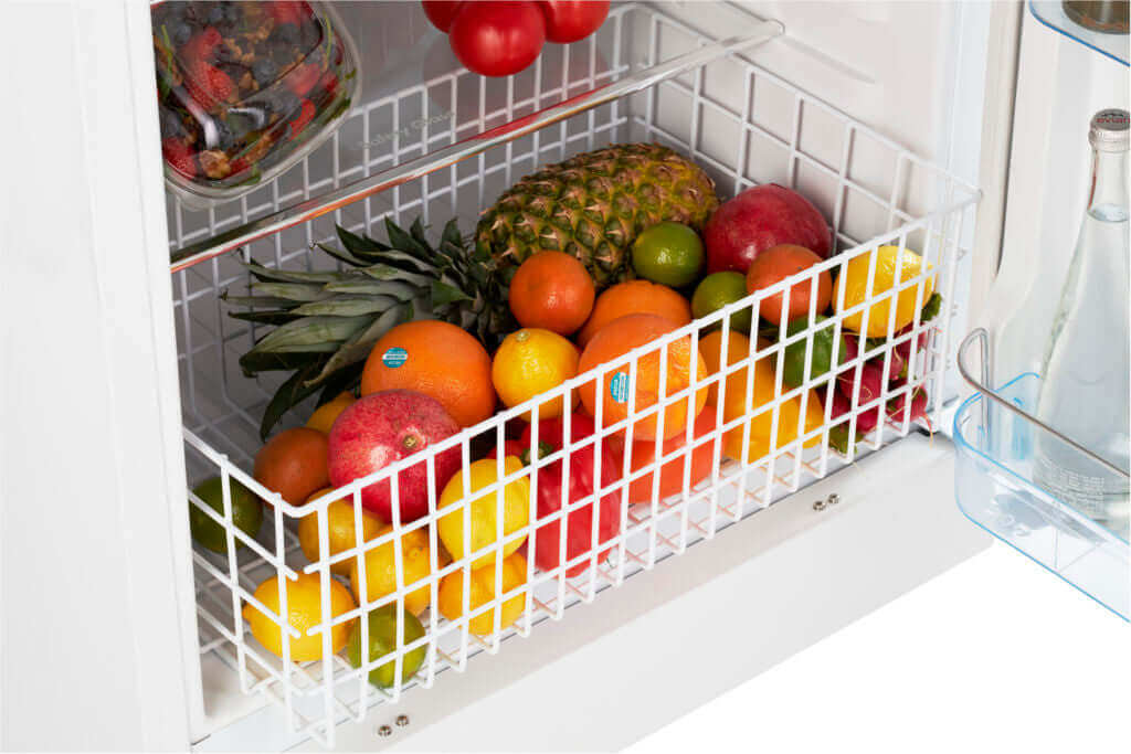 Interior view of Unique 14 Cu/Ft Propane Fridge filled with fresh fruits, highlighting storage capacity for families at Cabin Depot.