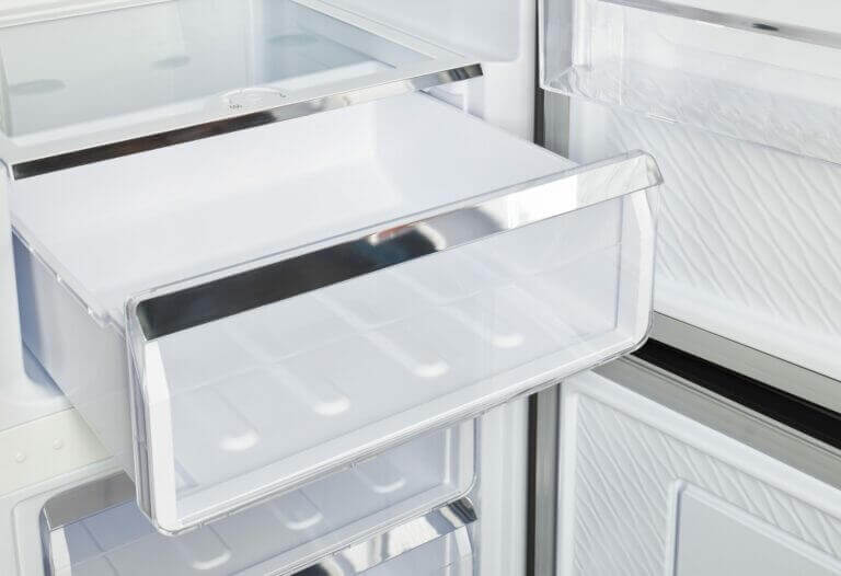 Open drawer of Unique 12 Cu/Ft Prestige Electric Bottom Mount Refrigerator with stainless steel design, available at Cabin Depot.
