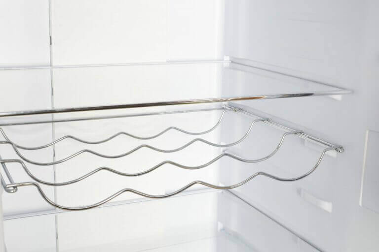 Wine rack shelf inside Unique Prestige 12 Cu/Ft Refrigerator, available at Cabin Depot, optimizes storage for modern kitchens.