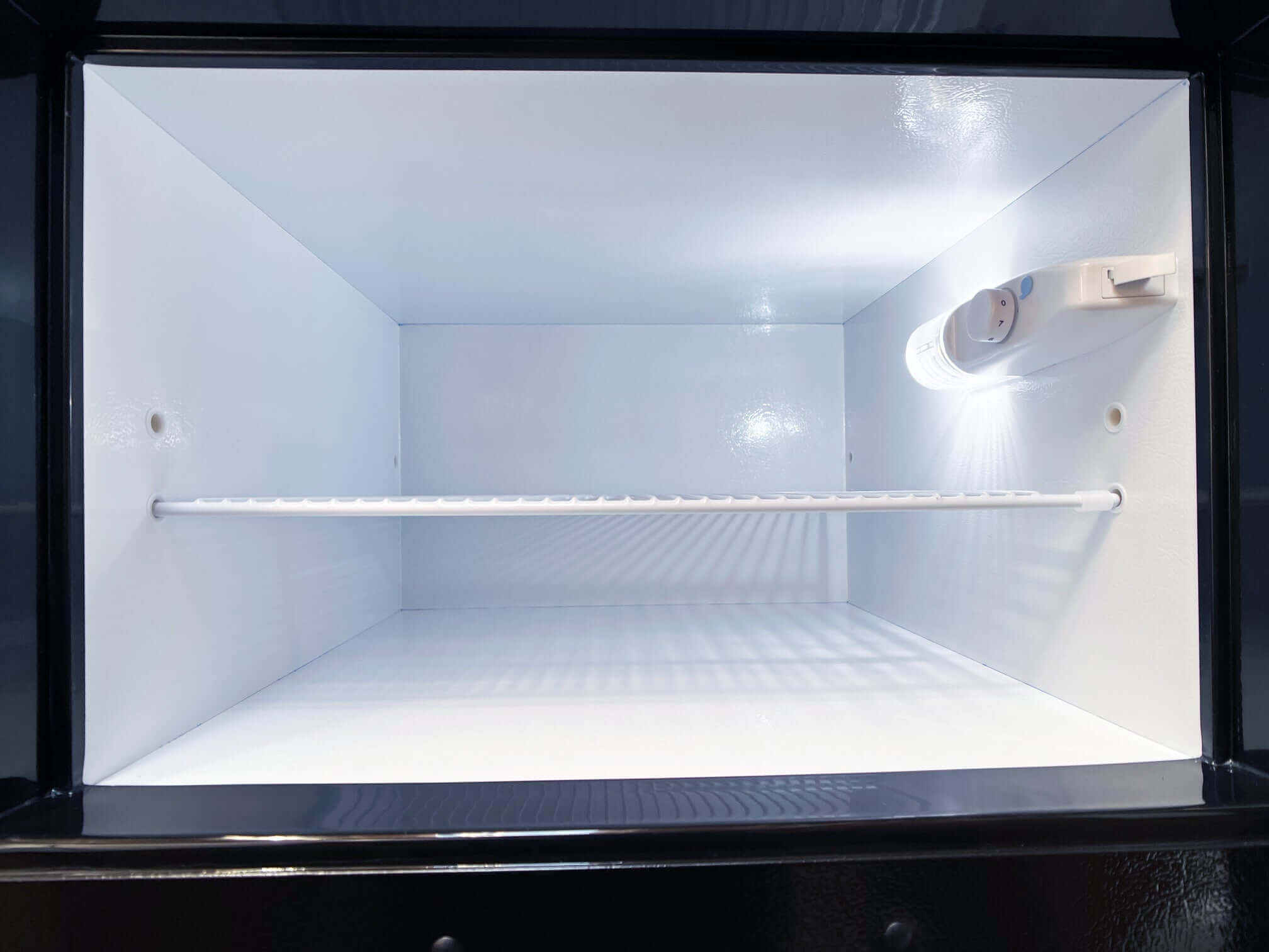 Interior view of SunStar 16CU Solar/DC Refrigerator with stainless steel doors, available at Cabin Depot.